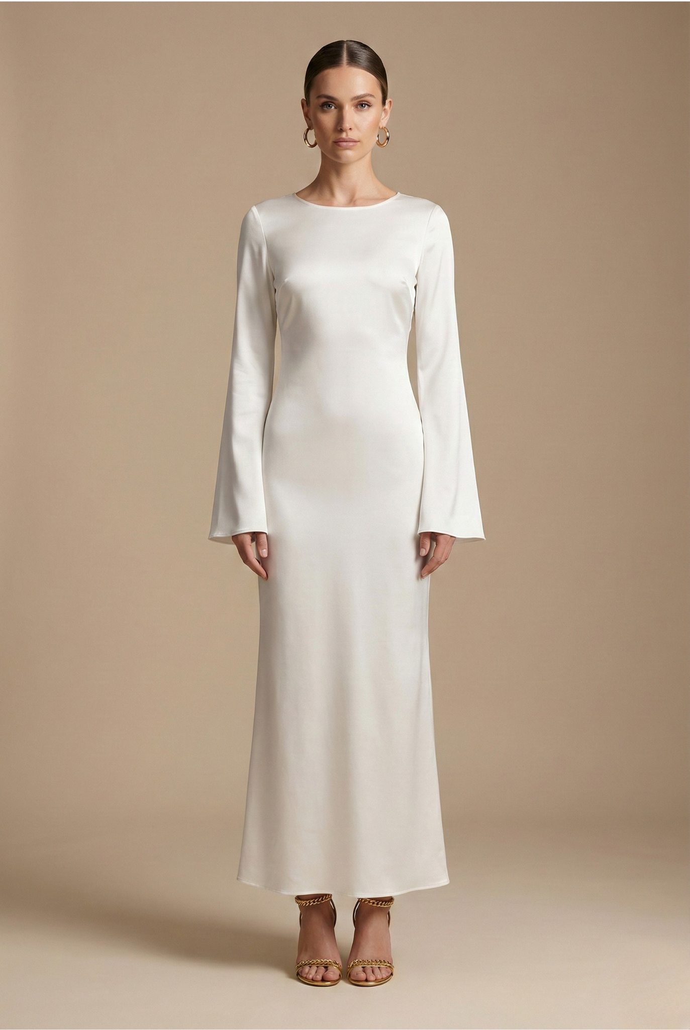 Cream satin maxi dress with long sleeves and round neckline, fitted column silhouette