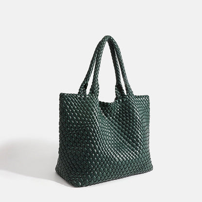 Deep green woven tote bag with top handles and textured basket-weave fabric