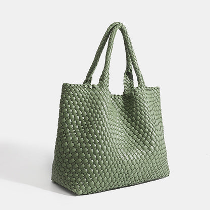 Green woven tote bag with top handles and textured basket-weave fabric
