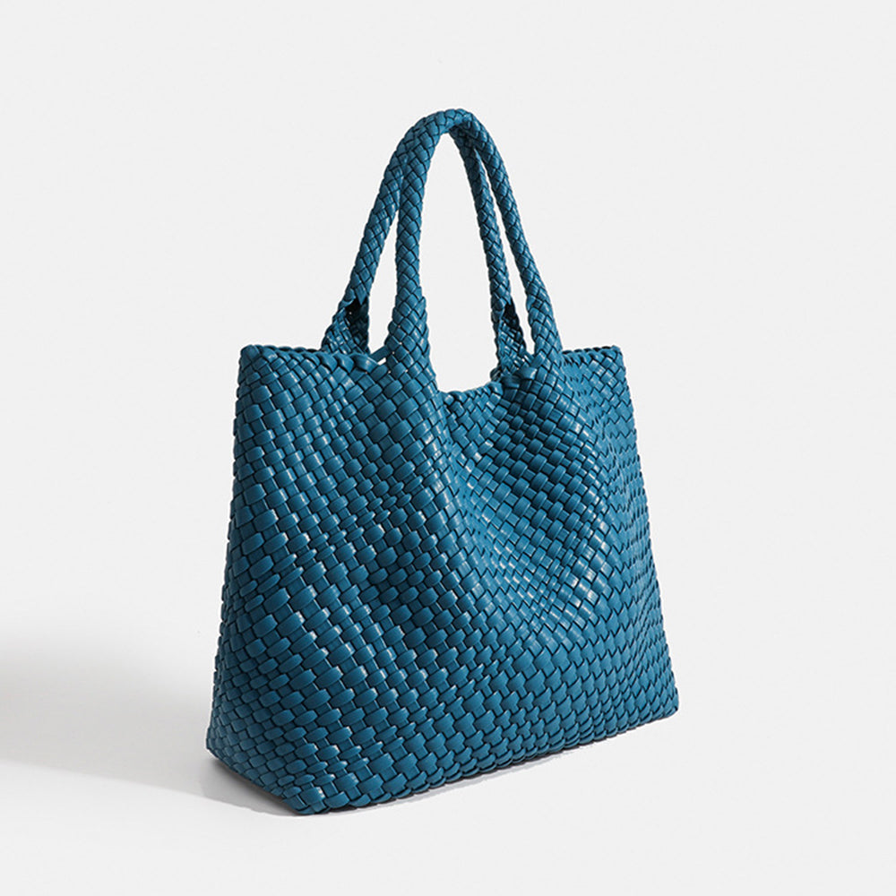 Blue woven tote bag with top handles and textured basket-weave fabric