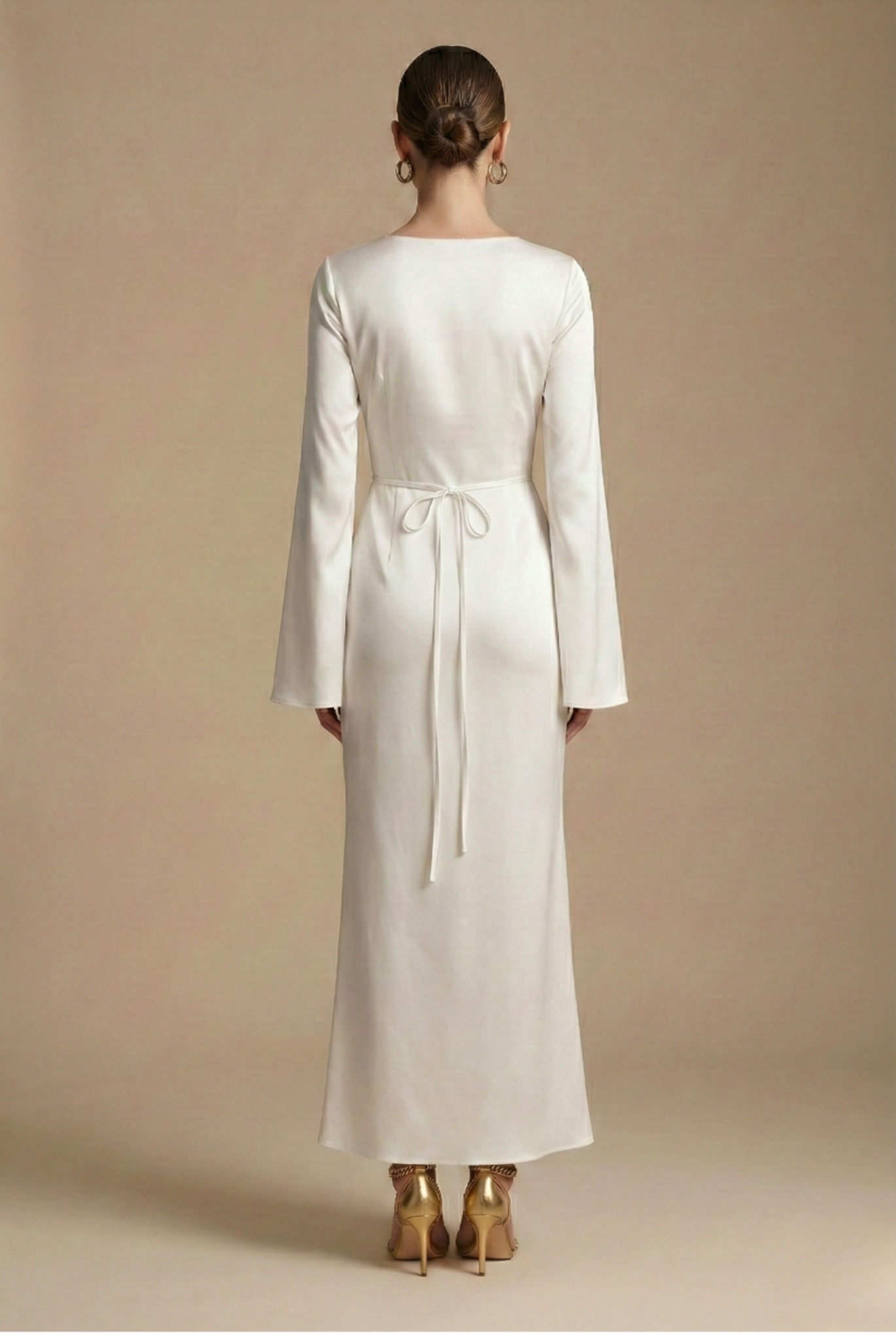 Back-view cream satin maxi dress with long sleeves, round neckline, waist tie