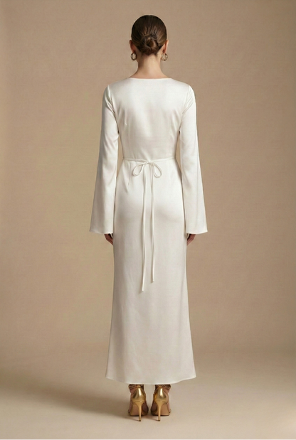 Back-view cream satin maxi dress with long sleeves, round neckline, waist tie